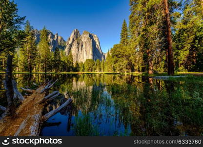 Middle Cathedral Rock reflecting in Merced River at Yosemite National Park. California, USA.