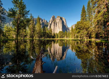 Middle Cathedral Rock reflecting in Merced River at Yosemite National Park. California, USA.