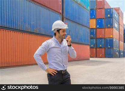 Middle east logistic worker engineer man working in cargo container warehouse industry factory site in export, import, and transportation concept. Business people lifestyle. Distribution service.