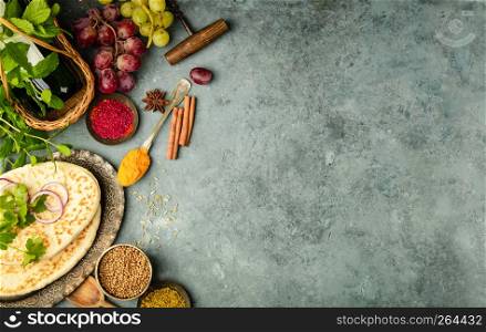 Middle eastern or arabic tradition ingredients - kebab bread, meat, wine, herbs and spices. Space for text, flat lay. Middle eastern or arabic tradition ingredients on dark background
