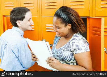 Middle school boy and girl talking together by the lockers.