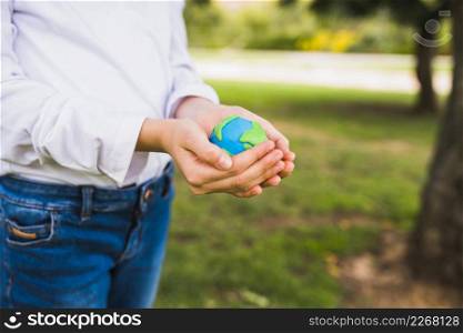 midsection girl holding globe cupped hands