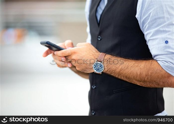 Midsection Of Man Using Phone