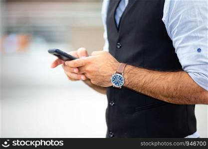 Midsection Of Man Using Phone