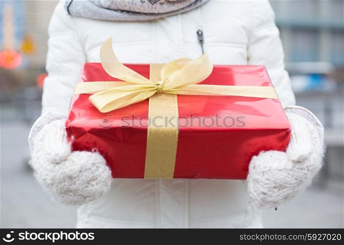 Midsection of woman holding gift box winter