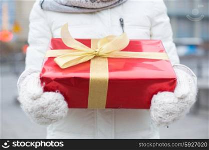 Midsection of woman holding gift box winter