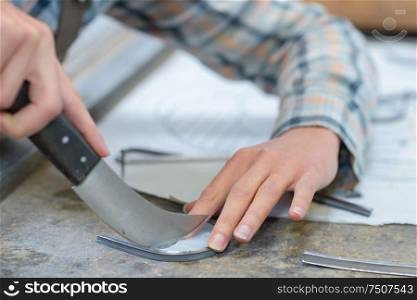midsection of woman using putty knife