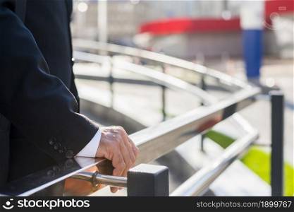 midsection view businessman s hand railing. Resolution and high quality beautiful photo. midsection view businessman s hand railing. High quality beautiful photo concept