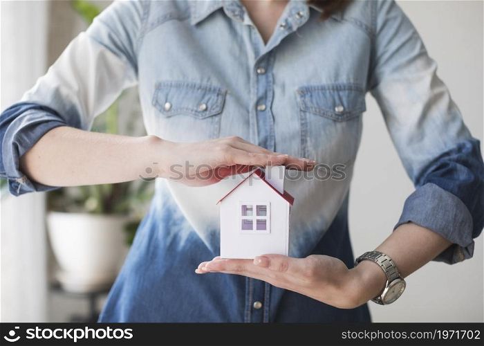 midsection woman protecting house model office. High resolution photo. midsection woman protecting house model office. High quality photo