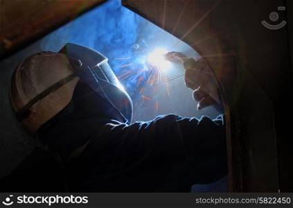 MIG welder uses torch inside of ship