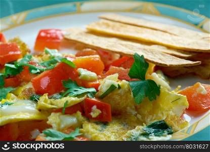 Migas Tex-Mex cuisine - migas is a traditional breakfast dish consisting of corn tortilla strips fried on a pan or griddle until almost crispy and then eggs.