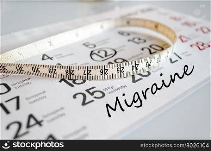 Migraine text concept over tape measure and calendar background&#xA;&#xA;