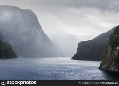 Milford Sound fiord in storm and rainy weather.&#xA;Fiordland national park, New Zealand