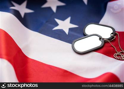military forces, military service, patriotism and nationalism concept - close up of american flag and soldiers badges