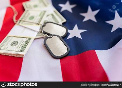military forces, recruitment, financing and national service concept - close up of american flag, dollar money and military badges