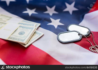 military forces, recruitment, financing and national service concept - close up of american flag, dollar money and military badges