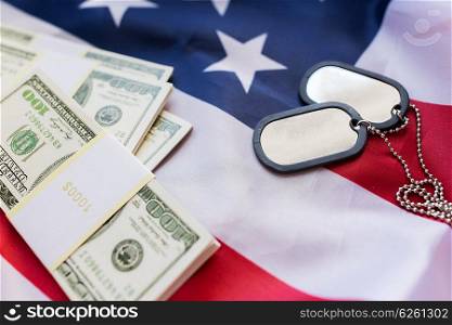 military forces, recruitment, financing and national service concept - close up of american flag, dollar money and military badges