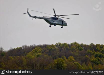 Military helicopter above forest view, Mi-8 transponter
