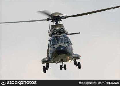 Military helicopter in flight towards camera