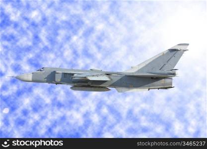 Military jet bomber Su-24 against clouds