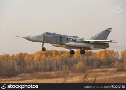 Military jet bomber Su-24 Fencer flying. Military jet bomber Su-24 Fencer flying above ground.