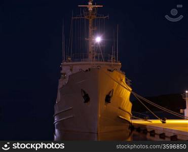 military ship anchored in winter night