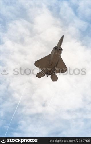 military stealth fighter speeding through the sky