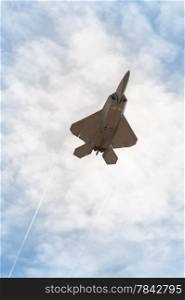 military stealth fighter speeding through the sky