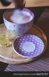 Milk and honey in bar. Violet color cup. Bulgaria