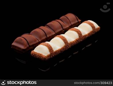 Milk and white chocolate sweet bars on black background