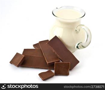 Milk chocolate and milk jug on a white background