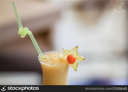 Milk cocktail with orange and carom. Milk cocktail