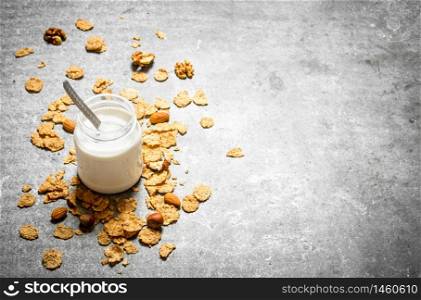Milk dessert cereal and nuts. On the stone table.. Milk dessert cereal and nuts.