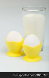 Milk in a glass jar and eggs on the table