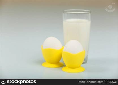 Milk in a glass jar and eggs on the table