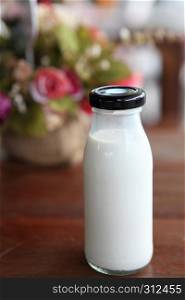 milk in bottle on wood background