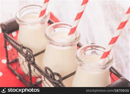 Milk in bottles with paper straws for children. Milk in bottles