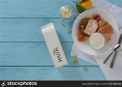 milk in carton box and baking on blue wooden background, top view. healthy eating concept. dairy products on a blue background