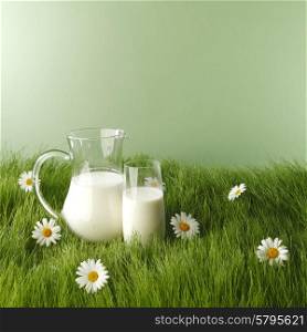 Milk in jar and glass on fresh grass meadow with chamomiles. Milk in jar and glass on flower meadow