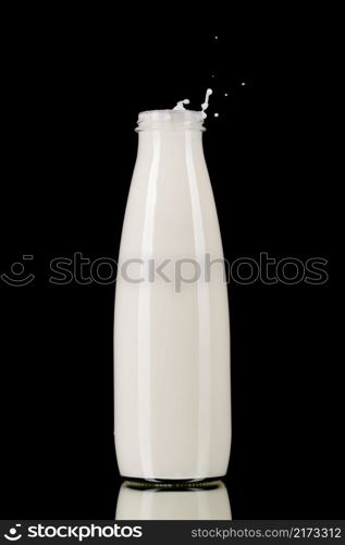 Milk in the bottle isolated on black background. Bottle of milk on black