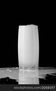 Milk in the glass isolated on black background. Glass of milk on black