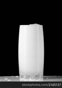 Milk in the glass isolated on black background. Glass of milk on black