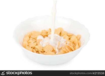 Milk pouring in a bowl of cornflakes closeup
