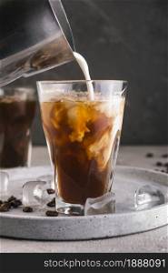 milk pouring into glass with coffee. Resolution and high quality beautiful photo. milk pouring into glass with coffee. High quality and resolution beautiful photo concept