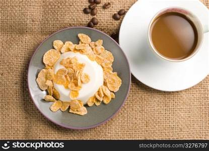 Milk pudding with sweet crisps and coffee on linen background