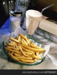 Milk shake and a plate of French fries