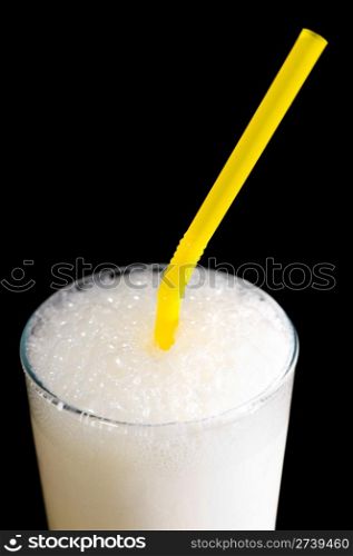milk shake in a glass with a straw, macro