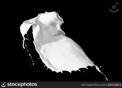 milk splash. White milk splash isolated on black background
