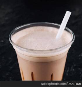milkshake in a plastic cup on black background