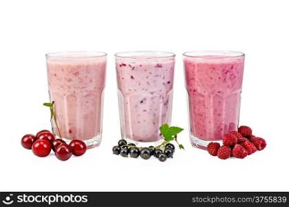 Milkshakes with black currant, cherry, raspberry in glass isolated on white background